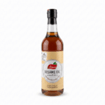 Khawla premium sesame oil bottle, amber liquid, clear glass, beige label.